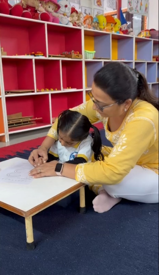 Teacher helping student in classroom